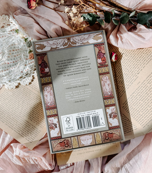 Book titled 'This Fatal Kiss' by Alicia Jasińska on an open book with floral and lace decorations.