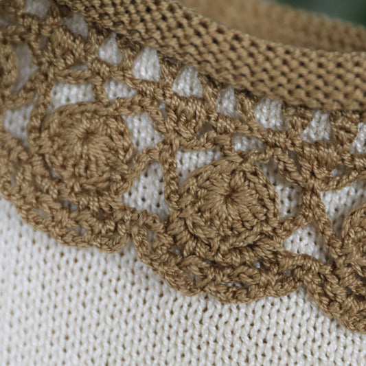 Beige sock with brown lace trim on a white background