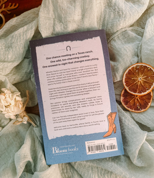 Book titled 'Duke' by Jessica Peterson on a textured surface with dried flowers and oranges.