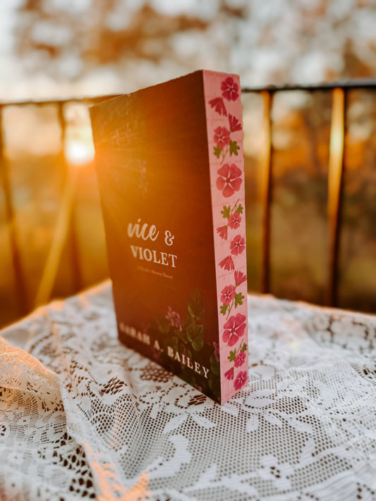 Book titled 'Vice & Violet' by Sarah A. Bailey on a lace doily