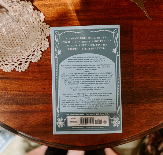 Book cover of 'Down Pour' by Maggie Gates on a wooden surface with decorative items.