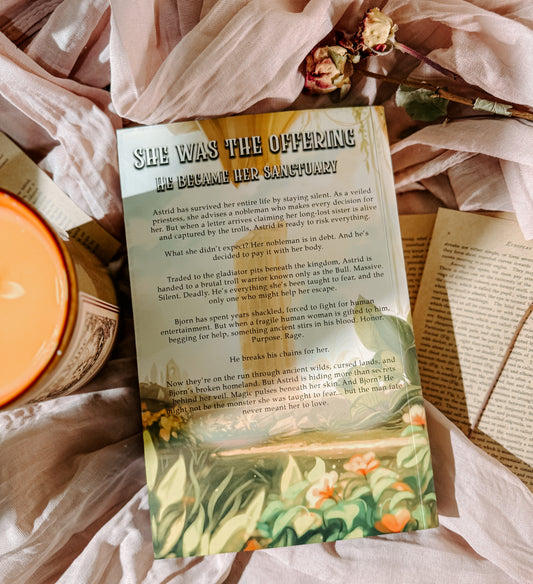 Book titled 'A Light Blinding' by Emma Newman on a soft fabric background with a candle.