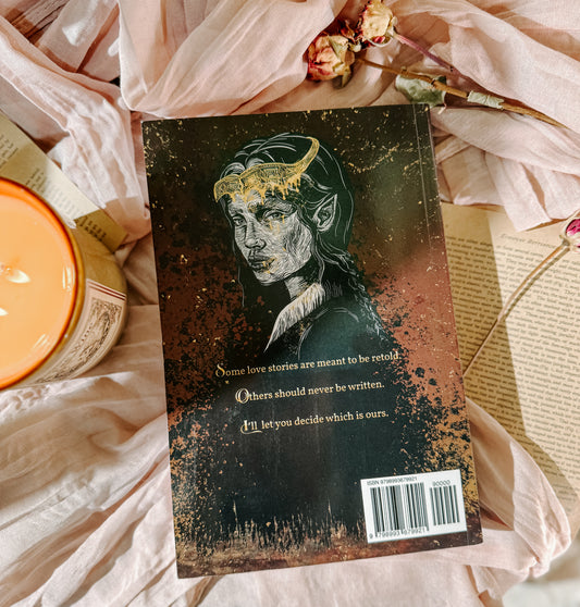 Book titled 'kingdom  of Silent Sorrows' by A.G. Harris on a soft fabric background with flowers and a candle.