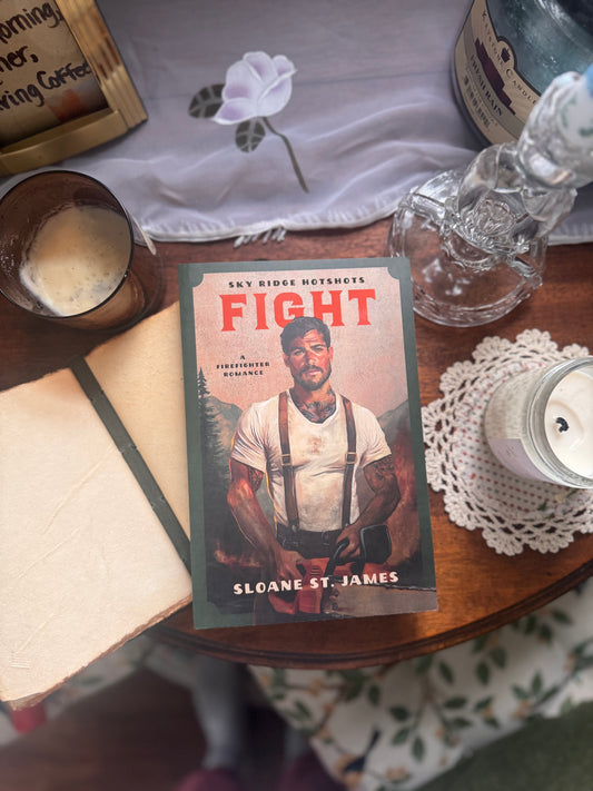 Book titled 'Fight' by Sloane St. James on a table with a bottle and other items.