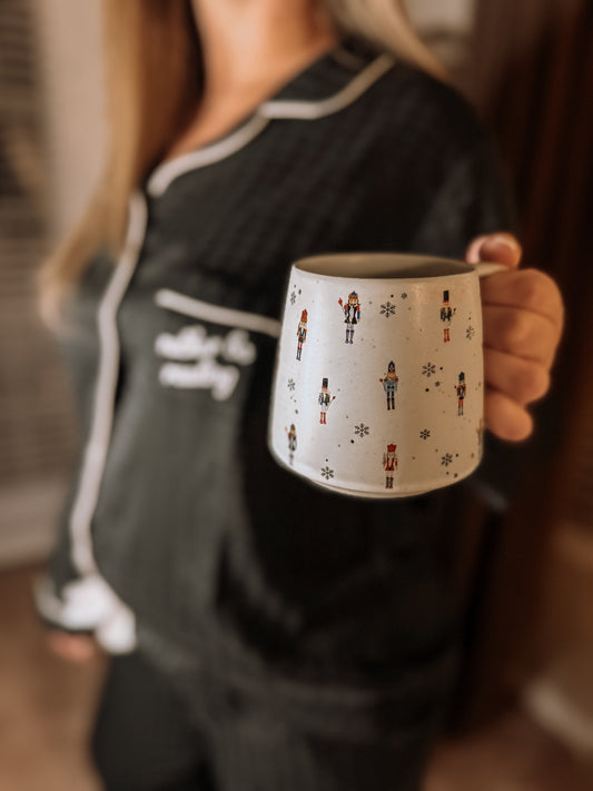Ceramic mug with nutcracker design on a white background