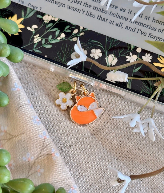 Fox charm on a clear pouch with floral design in the background dust plug charm 