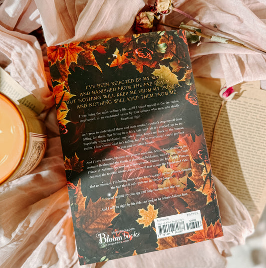 Book titled 'Woven by Gold' by Elizabeth Helen on a soft fabric background with a candle.