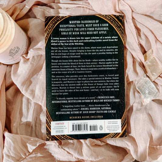 Book titled 'House of Hunger' by Alexis Henderson on a textured surface