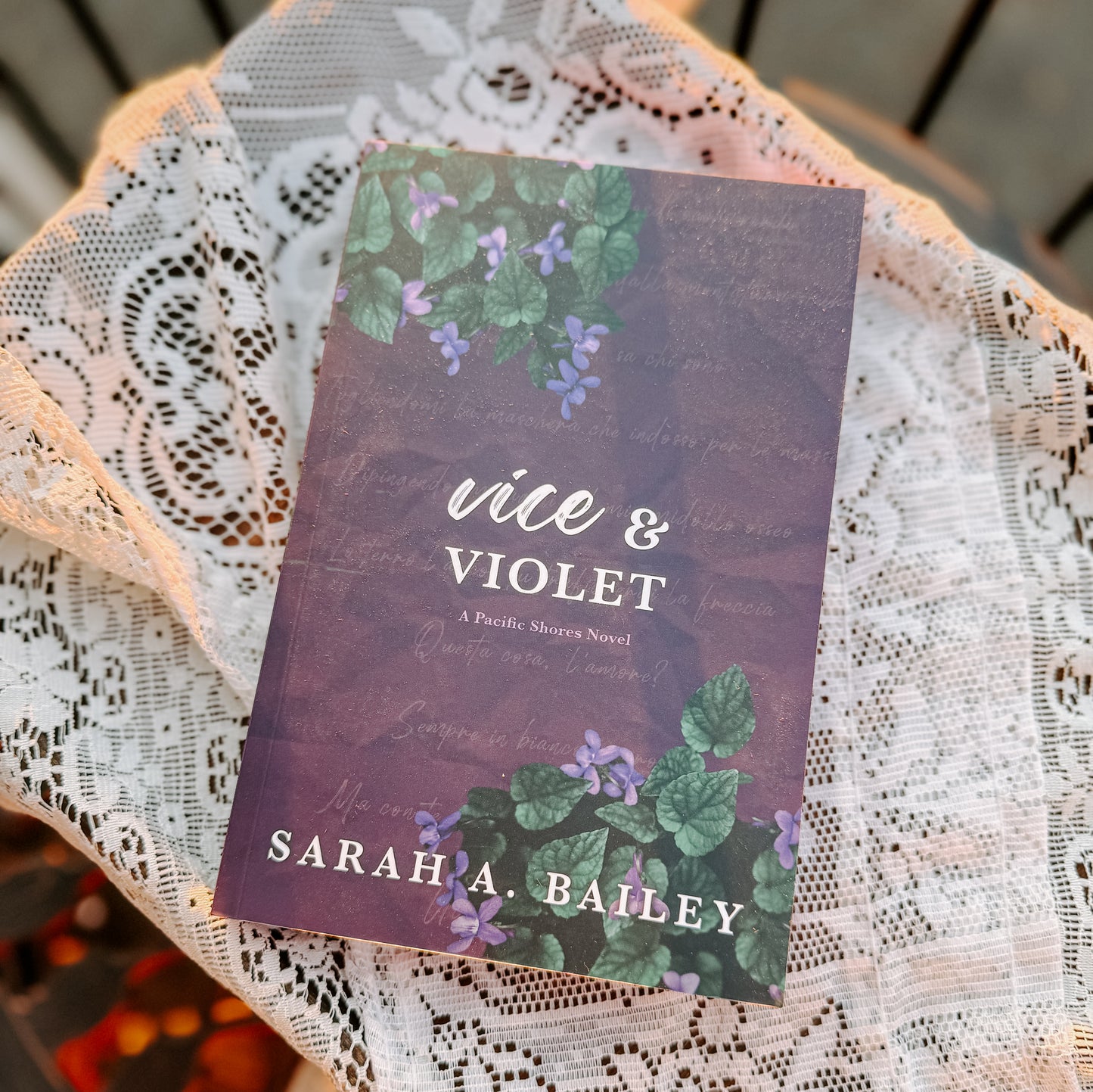 Book titled 'Vice & Violet' by Sarah A. Bailey on a lace doily