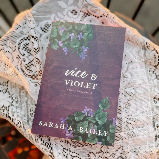 Book titled 'Vice & Violet' by Sarah A. Bailey on a lace doily