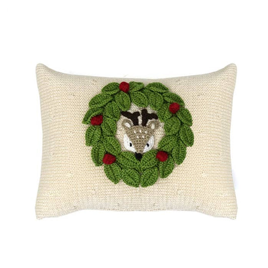 Decorative pillow with a crochet deer  in a wreath design on a white background