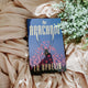 Book titled 'The Arachnid' by I.V Ophelia on a soft fabric background with greenery.