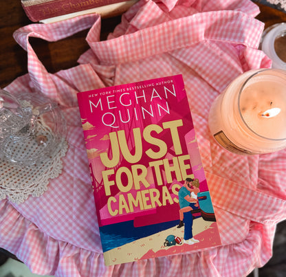 Just for the cameras by Megan Quinn. 
