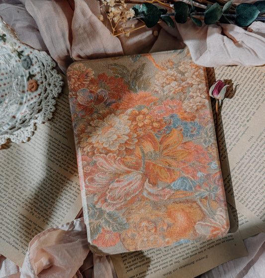 Floral-patterned kindle case  on an open book with a soft focus background
