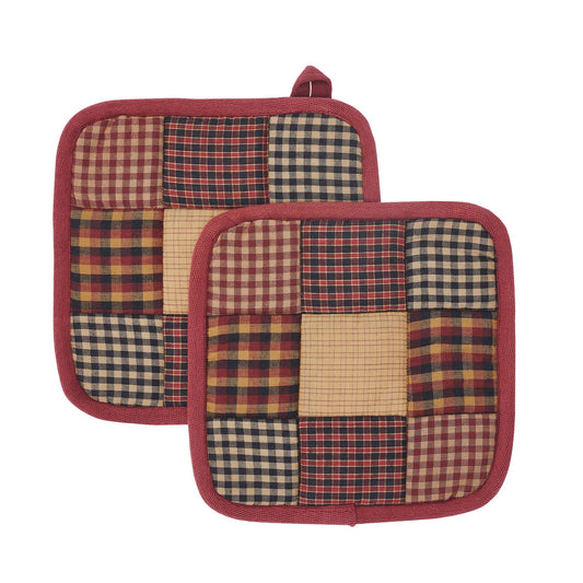 Pair of patchwork potholders on a wooden surface with love , Meena 