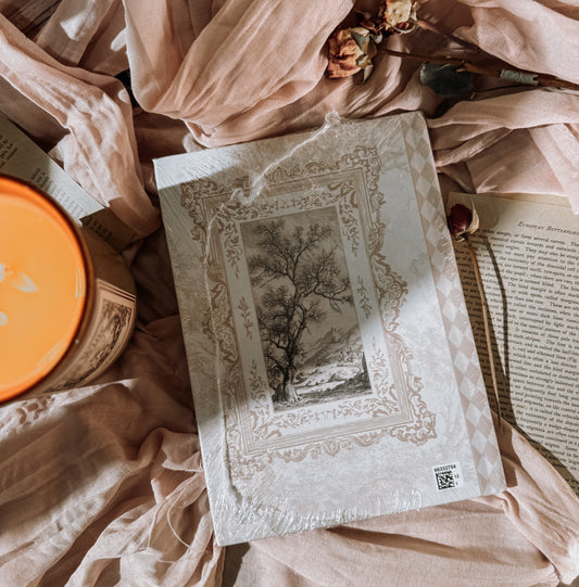 Decorative journal with ornate cover on a soft fabric background