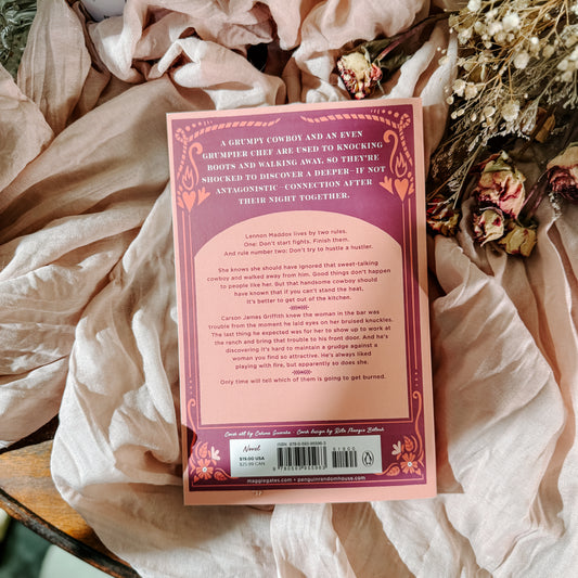 Book titled 'Fire Line' by Maggie Gates on a soft fabric background with flowers.