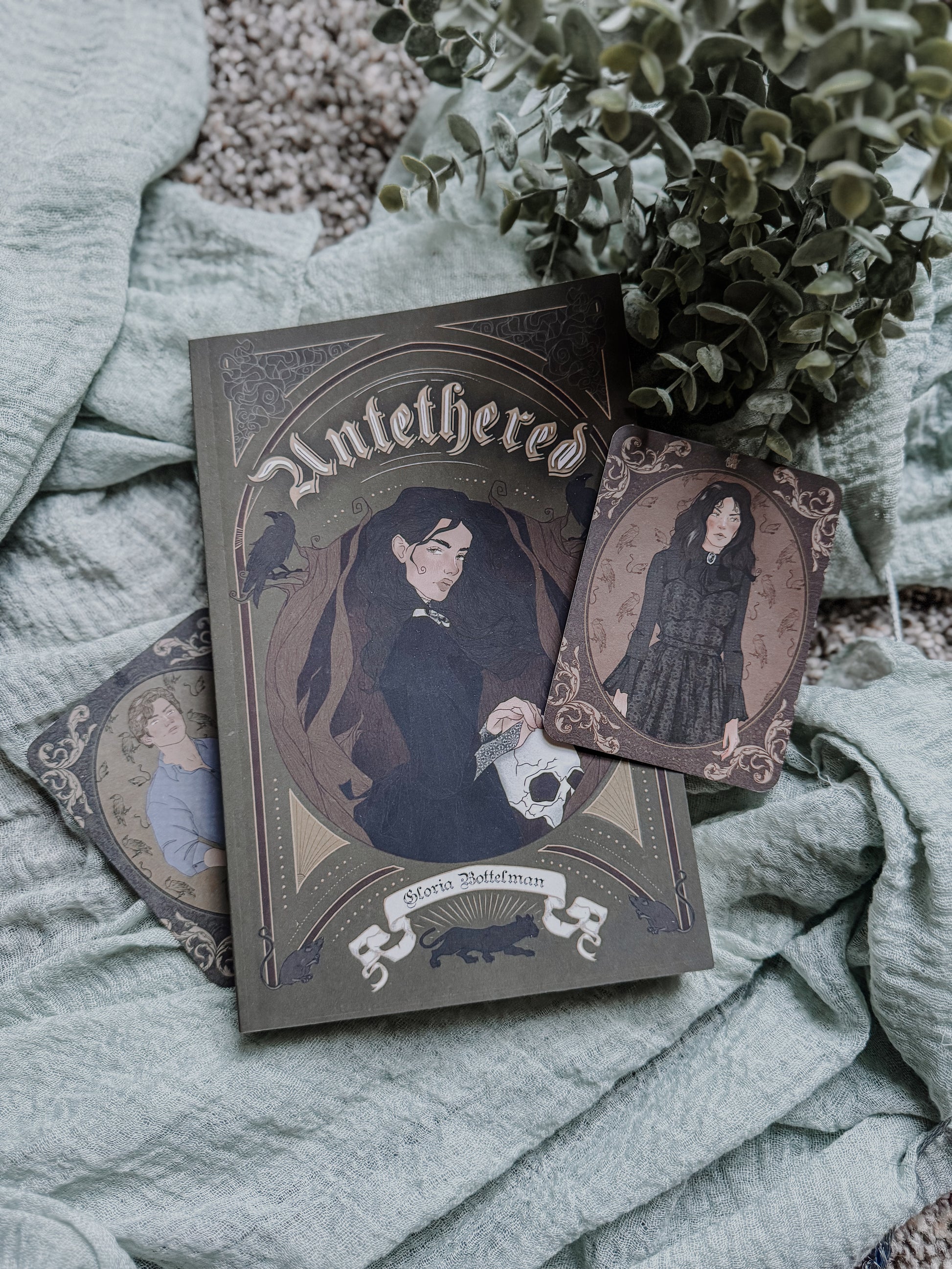 Book titled 'untethered ' with illustrations on a textured surface with plants.