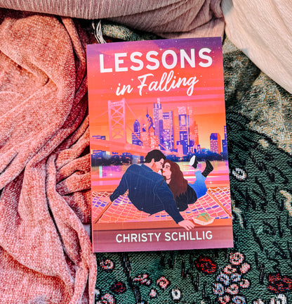 Book titled 'Lessons in Falling' by Christy Schillig on a textured fabric background