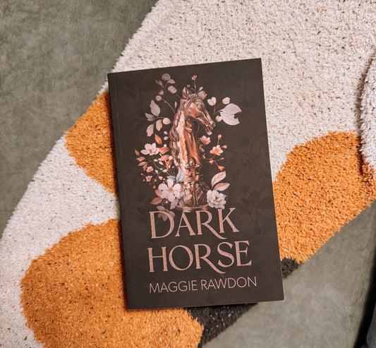 Book titled 'Dark Horse' by Maggie Rawdon on a textured surface