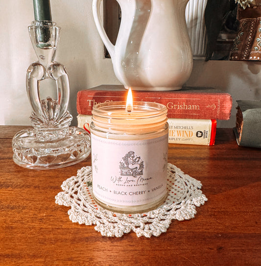 With love Meena signature candle. Peach black cherry and vanilla 
