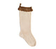 Beige sock with brown lace trim on a white background
