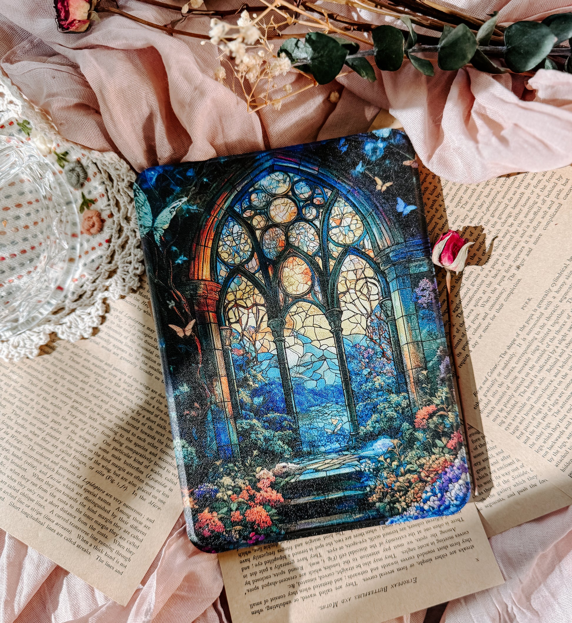 Decorative kindle case  with stained glass design on a floral and text background
