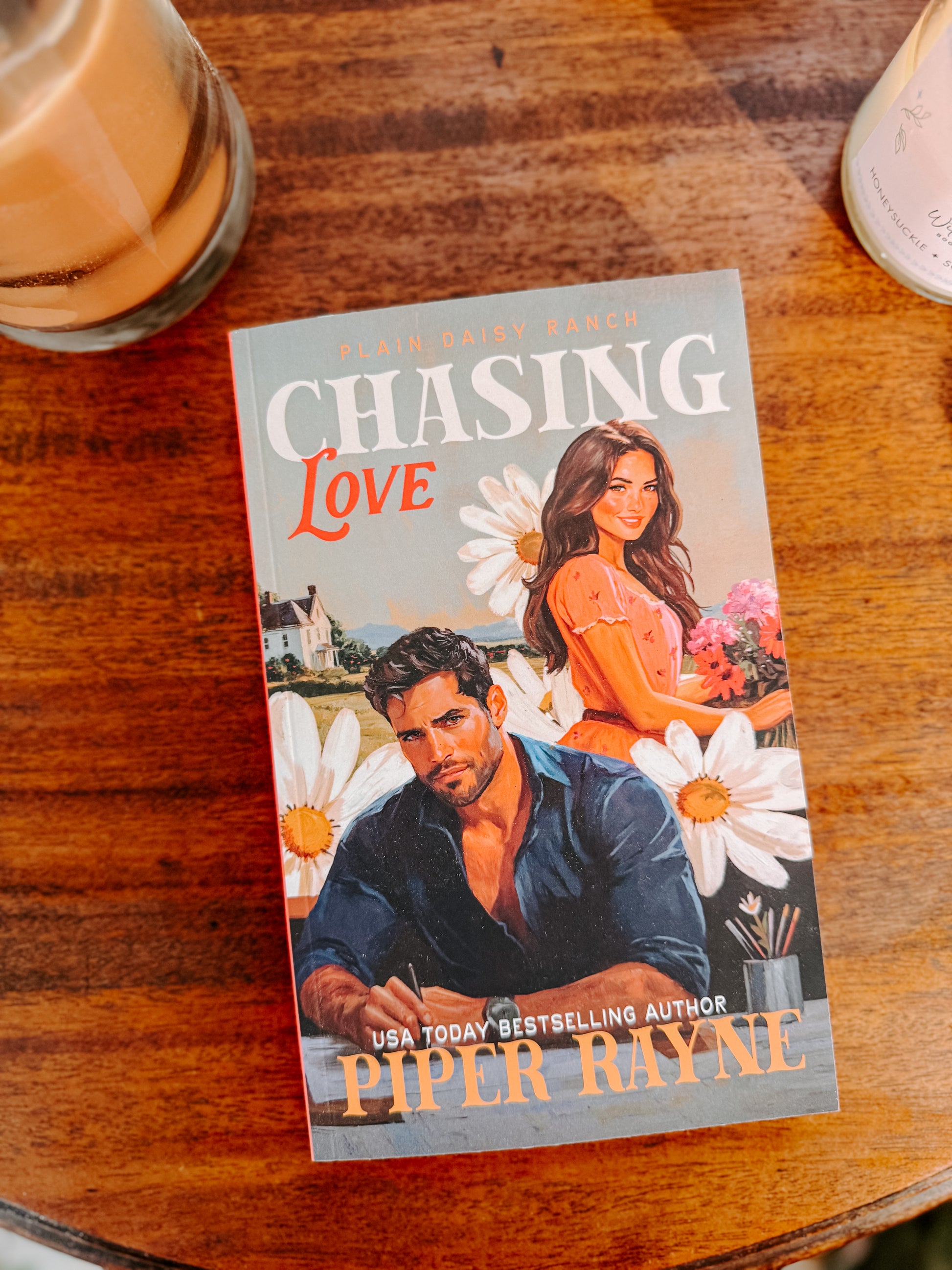 Book titled 'Chasing Love' by Piper Rayne on a wooden surface with a cup of coffee.