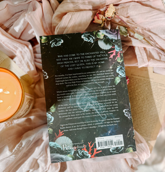 Book titled 'Broken by Daylight' by Elizabeth Helen on a soft fabric background with a candle.