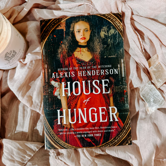 Book titled 'House of Hunger' by Alexis Henderson on a textured surface
