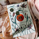 Book titled 'Divine Rivals' by Rebecca Ross with floral design on a soft fabric background