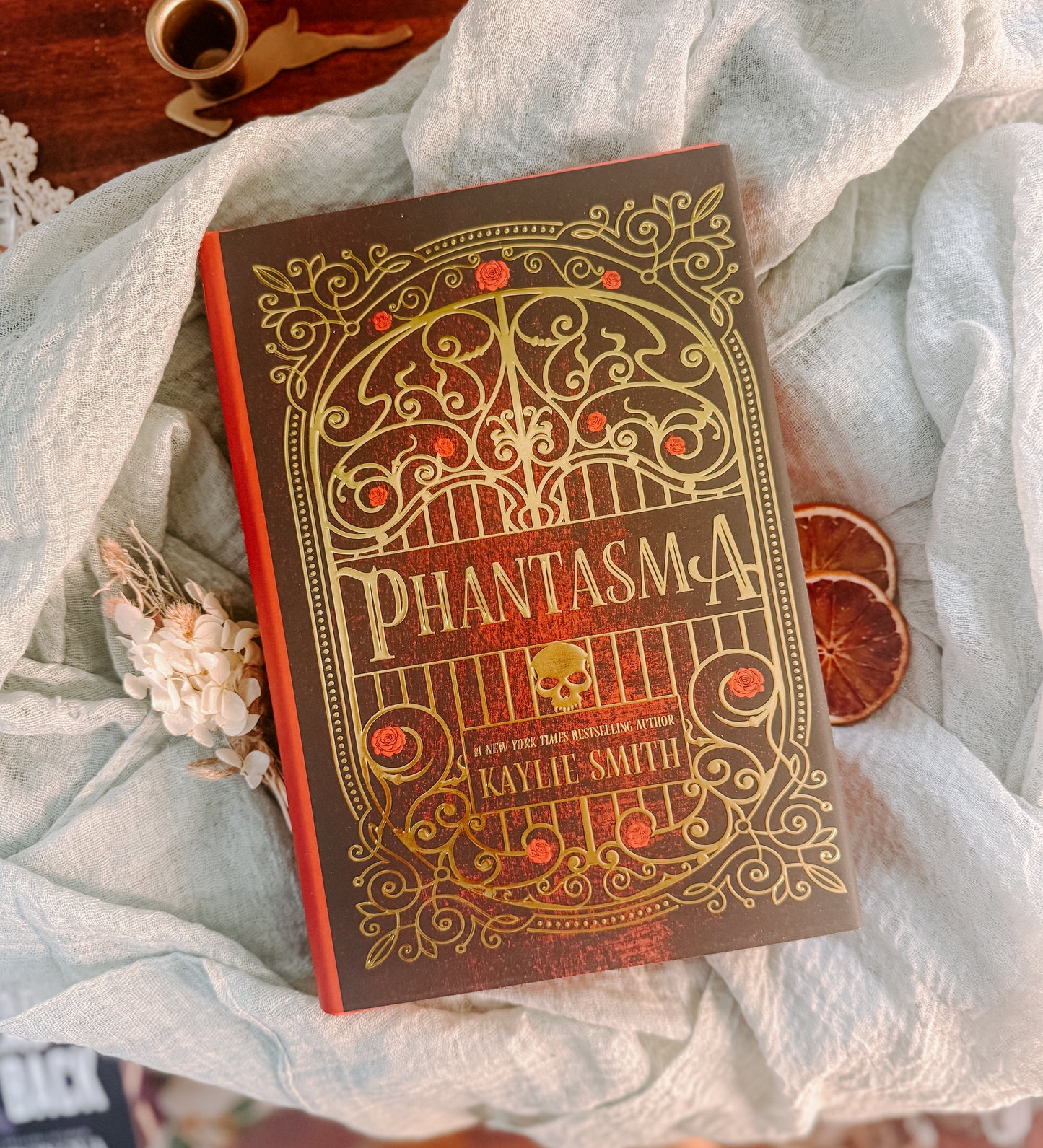 Book titled 'Phantasma' by Kaylie Smith on a textured surface with decorative elements. Deluxe limited edition 