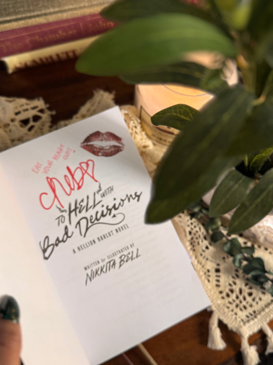 Book titled 'Hellish Bad Deliveries' on a lace tablecloth with a plant in the background