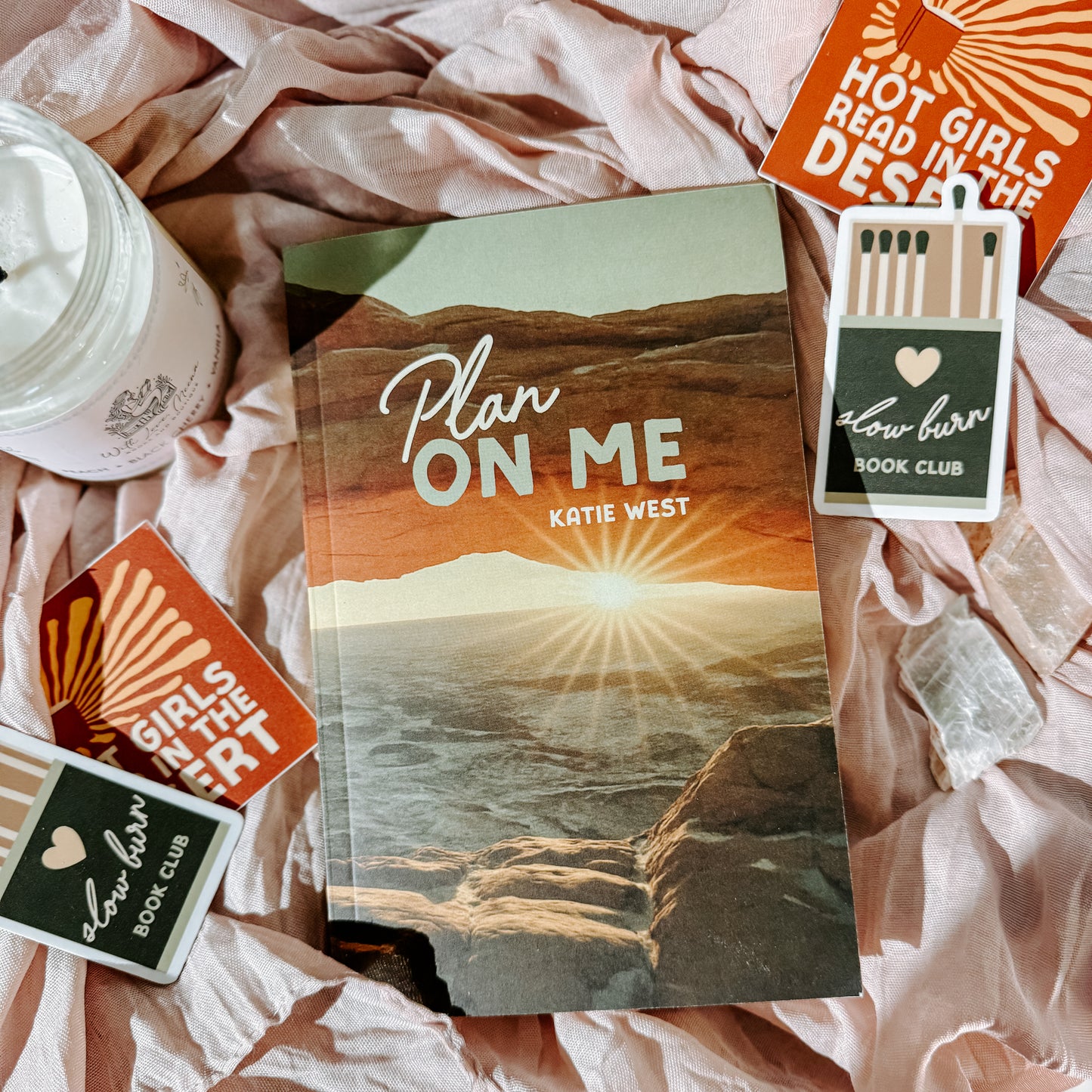 Book titled 'Plan On Me' by Katie West with decorative items on a textured surface