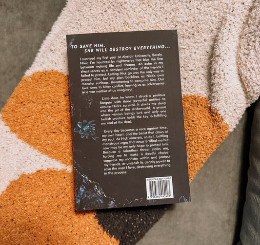 Book titled 'Venomous' by Nicole M. Rubino on a textured surface