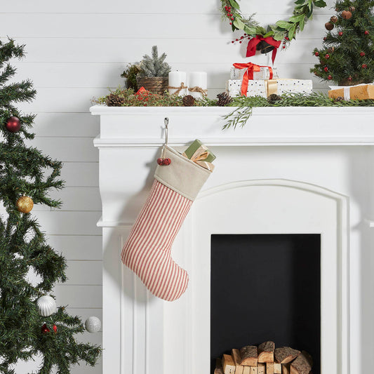 Christmas stocking hanging on a white fireplace with decorative elements.