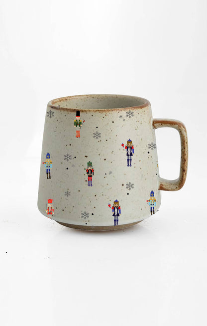 Ceramic mug with nutcracker design on a white background